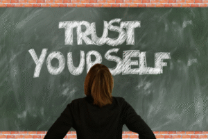 woman facing board that has trust yourself quote