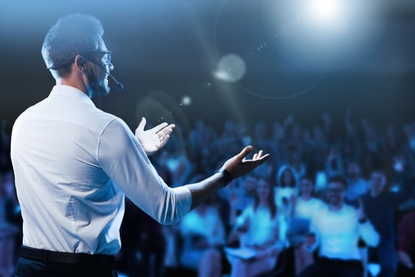 Confident speaker engaging audience with NLP public speaking techniques