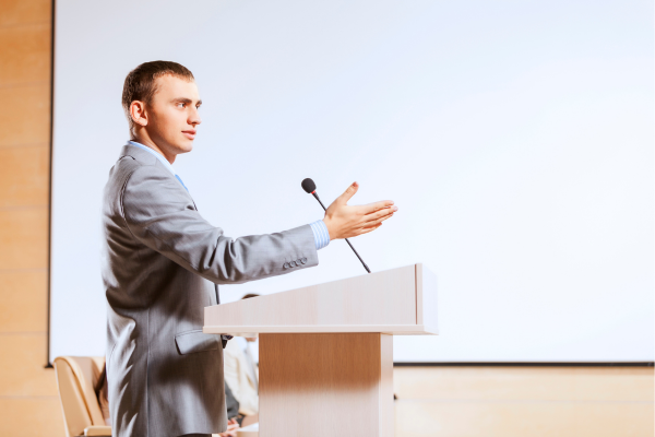 Public speaker using pauses to emphasize points with confidence