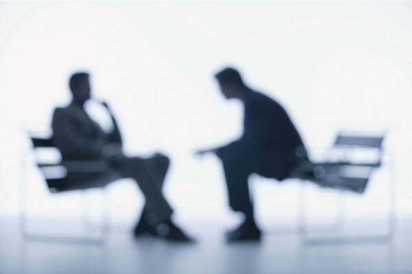 Two people mirroring each other’s body language naturally
