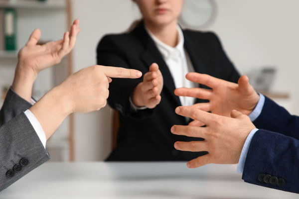 Team resolving workplace conflict through professional discussion